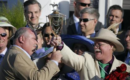 Steven Coburn, right, and Perry Martin hold the trophy after California Chrome won the Kentucky Derby. (AP)