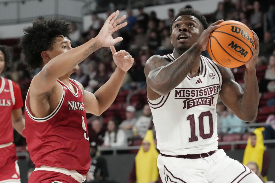 Mississippi State guard Dashawn Davis (10) attempts a layup while defended by Nicholls State guard Michael Gray Jr. (9) during the first half of an NCAA college basketball game in Starkville, Miss., Friday, Nov. 24, 2023. (AP Photo/Rogelio V. Solis)