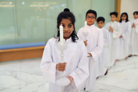 Expat children hold the candles while serving during the mass at St. Francis of Assisi Catholic Church in Jebel Ali, as Catholics are awaiting a historical visit by Pope Francis to the United Arab Emirates, in Dubai, UAE January 18, 2019. REUTERS/Ahmed Jadallah