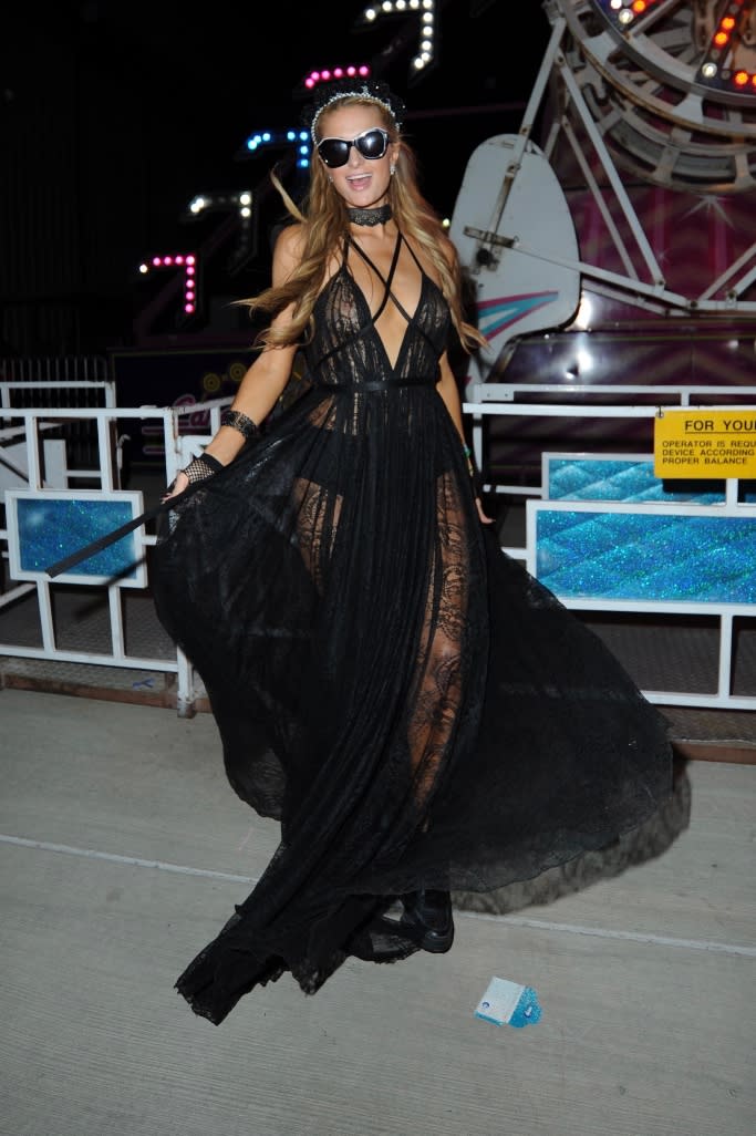 Paris Hilton shows off a dramatic black dress at Neon Carnival at Coachella on April 15, 2017. - Credit: DUTCH / MEGA