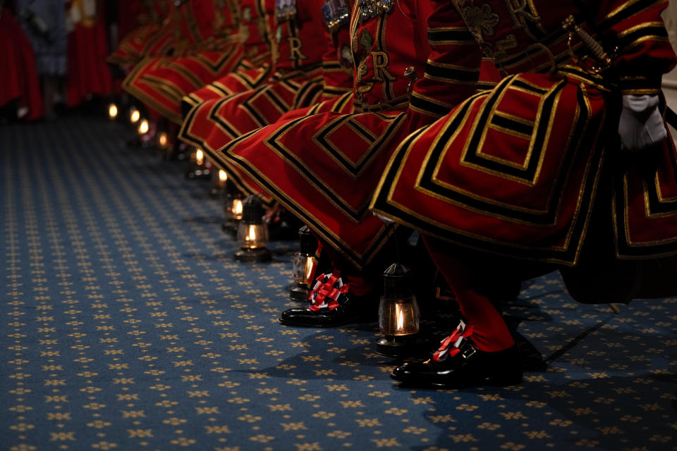 Yeomen Warders pick up their lanterns for the ceremonial search of the Palace of Westminster prior to the State Opening of Parliament in London, Tuesday, May 10, 2022. Buckingham Palace said Queen Elizabeth II will not attend the opening of Parliament on Tuesday amid ongoing mobility issues. (AP Photo/Alastair Grant, Pool)