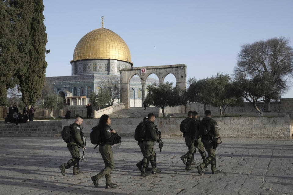 Israeli police escort Jewish visitors marking the holiday pf Passover to the Al-Aqsa Mosque compound, known to Muslims as the Noble Sanctuary and to Jews as the Temple Mount, following an overnight raid of the site, in the Old City of Jerusalem during the Muslim holy month of Ramadan, Wednesday, April 5, 2023. Palestinian media reported police attacked Palestinian worshippers, raising fears of wider tension as Islamic and Jewish holidays overlap.(AP Photo/Mahmoud Illean)