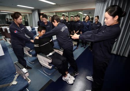 Cabin crews attend a training session on how to manage in-flight disturbances in Seoul, South Korea, December 27, 2016. Shin Joon-hee/Yonhap via REUTERS