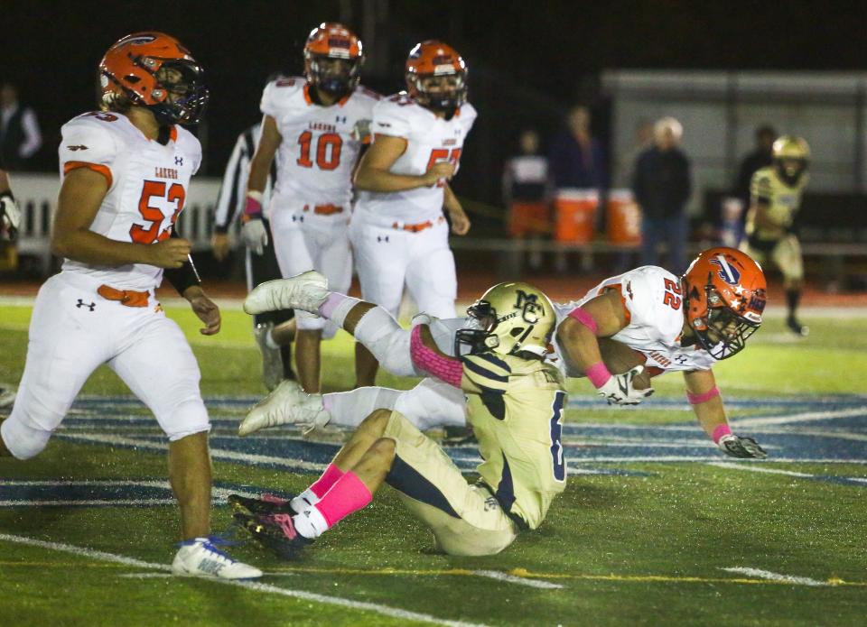 Morris Catholic's Nick Masotti takes down Mountain Lakes' Justin Hernando during the first half of a SFC National White football game at Morris Catholic High School on October 22, 2021. Alexandra Pais/ for the Daily Record