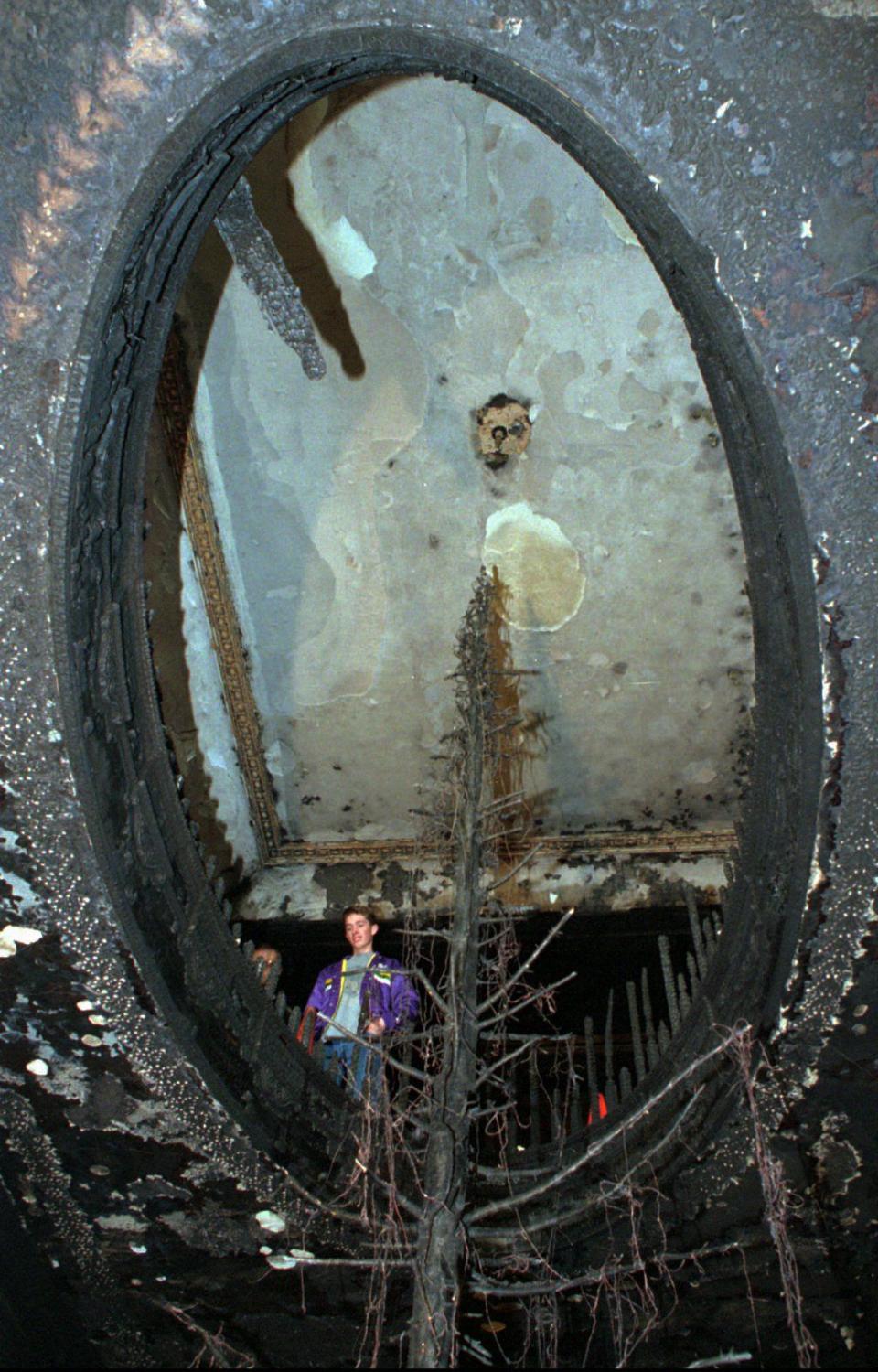 Utah state Governor’s son, Taylor Leavitt, looks at damage done from christmas tree fire at the Governor’s mansion Wednesday, Dec. 15, 1993, before going into his room to inspect the damage. The four-alarm blaze caused more than 1 million dollars worth of damage and destroyed irreplaceable art and antiques. | Jeffrey D. Allred, Deseret News