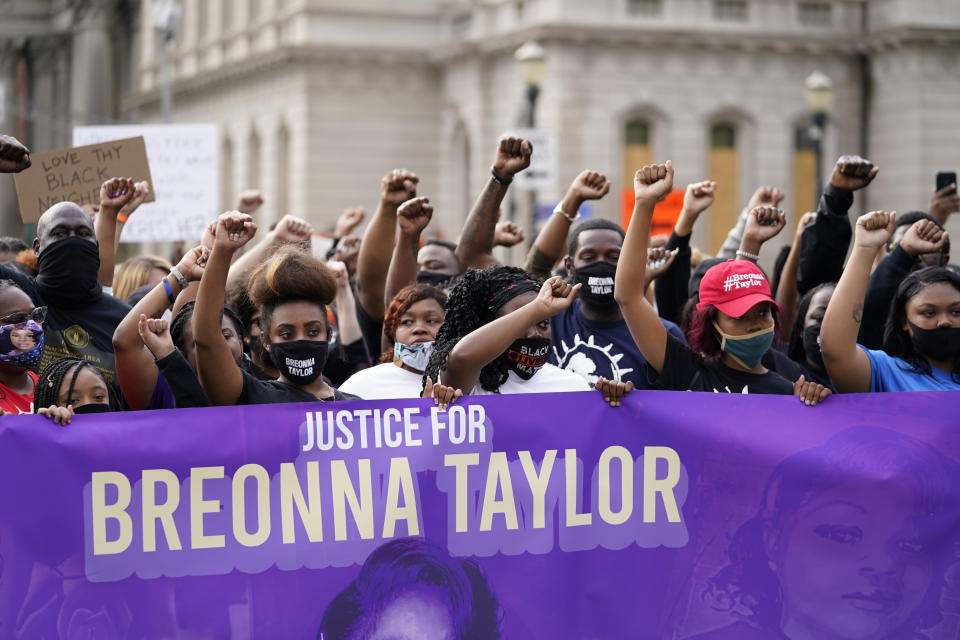 Black Lives Matter protesters march, Friday, Sept. 25, 2020, in Louisville. Breonna Taylor's family demanded Friday that Kentucky authorities release all body camera footage, police files and the transcripts of the grand jury hearings that led to no charges against police officers who killed the Black woman during a March drug raid at her apartment. (AP Photo/Darron Cummings)