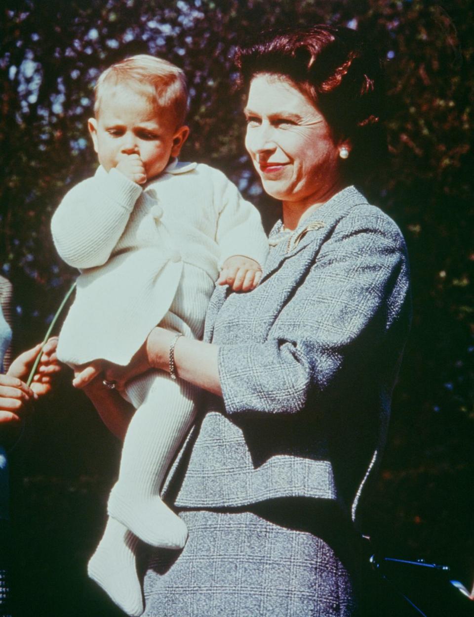 <p>Queen Elizabeth II holds her son Prince Edward, aged one.</p>