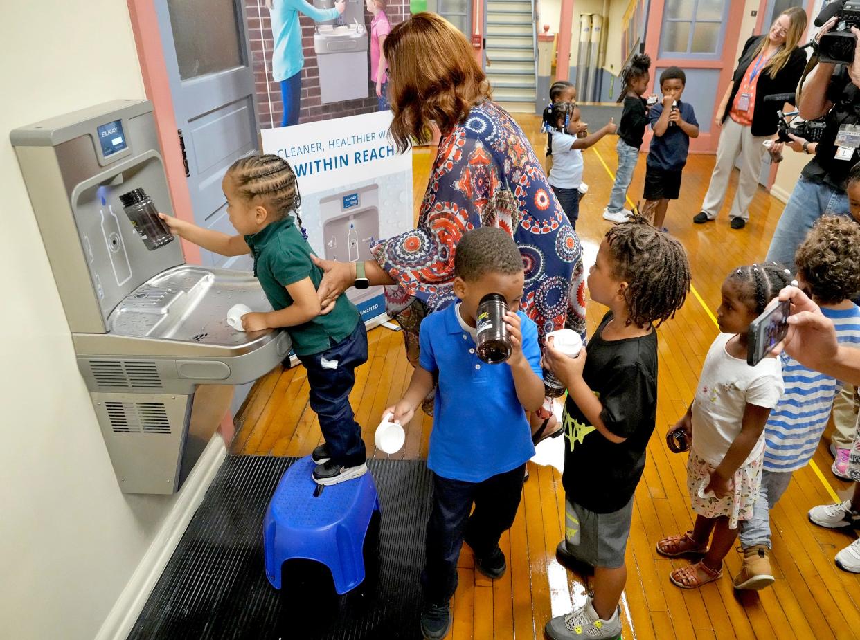 K4 and K5 students fill their water bottles from the new filtered drinking fountain with the help of assistant principal Cynthia Bush at Frances Brock Starms Early Childhood Center on West Garfield Avenue in Milwaukee on Monday. Milwaukee Public Schools has installed nearly 600 new Elkay filtered bottle filling stations.