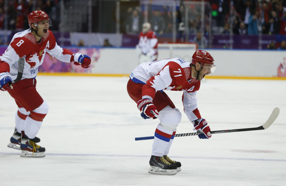 Russia forward Ilya Kovalchuk and Russia forward Alexander Ovechkin react after Kovalchuk scored a goal against Finland in the first period of a men's quarterfinal ice hockey game at the 2014 Winter Olympics, Wednesday, Feb. 19, 2014, in Sochi, Russia. (AP Photo/Julio Cortez)