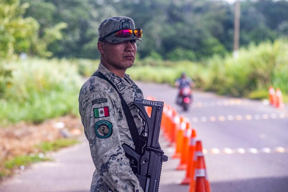 A Mexican National Guard soldier is photographed at the first checkpoint north of the border between Mexico and Guatemala. Migrants without proper documentation will get off public transportation just a few hundred yards from this checkpoint and walk around in order to not be detected by Mexican officials.