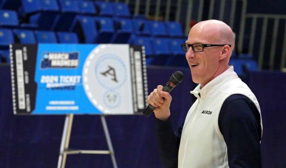 Akron Zips head coach John Groce smiles as he speaks to his team and fans during the Akron Zips' watch party for the NCAA Tournament Selection Show at James A. Rhodes Arena, Sunday, March 17, 2024, in Akron, Ohio.