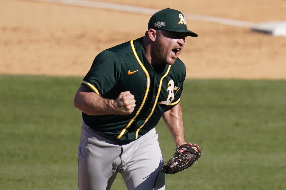 Oakland Athletics pitcher Liam Hendriks reacts after striking out Houston Astros' Josh Reddick during the eighth inning of Game 3 of a baseball American League Division Series in Los Angeles, Wednesday, Oct. 7, 2020. (AP Photo/Marcio Jose Sanchez)