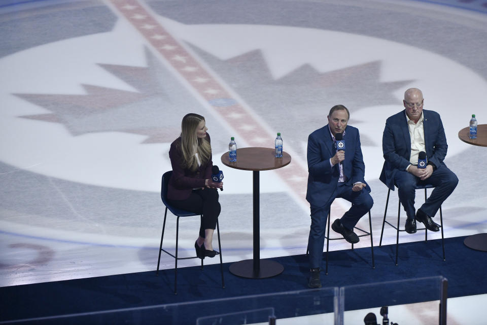 NHL Commissioner Gary Bettman, center, and Deputy Commissioner Bill Daly, right, speak to season-ticket holders before an NHL hockey game between the St. Louis Blues and the Winnipeg Jetss on Tuesday, Feb. 27, 2024, in Winnipeg, Manitoba. (Fred Greenslade/The Canadian Press via AP)