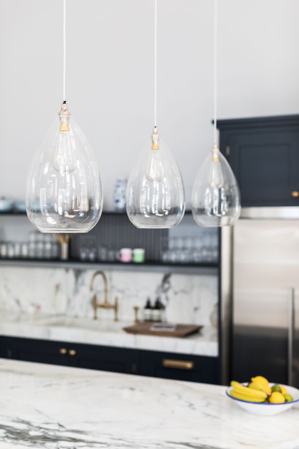 <p>From small pendants to statement shades, there are lots of ways to brighten up your kitchen island. If it's a space where you'll be preparing food then opt for bright task lighting, however if you're dreaming of creating a spot to unwind then consider something softer. </p><p>'Pendant lighting is an elegant addition that will bring an extra layer of interest to the kitchen's design,' says Graeme. 'The low hanging bulbs will offer extra light for everyday tasks without overwhelming the space.' </p><p>• Clear glass pendant, £215 from <a href="https://www.fritzfryer.co.uk/products/wellington-clear-glass-pendant-light/" rel="nofollow noopener" target="_blank" data-ylk="slk:Fritz Fryer;elm:context_link;itc:0;sec:content-canvas" class="link ">Fritz Fryer </a></p><p><strong>READ MORE</strong>: <a href="https://www.housebeautiful.com/uk/decorate/kitchen/a31990026/kitchen-lighting-ideas/" rel="nofollow noopener" target="_blank" data-ylk="slk:Kitchen lighting ideas for the hardest-working room in your house;elm:context_link;itc:0;sec:content-canvas" class="link ">Kitchen lighting ideas for the hardest-working room in your house</a></p>