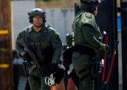 SWAT officers search a back alley after a San Diego police officer was fatally shot and another was wounded late on Thursday, in San Diego, California, United States July 29, 2016. REUTERS/Mike Blake