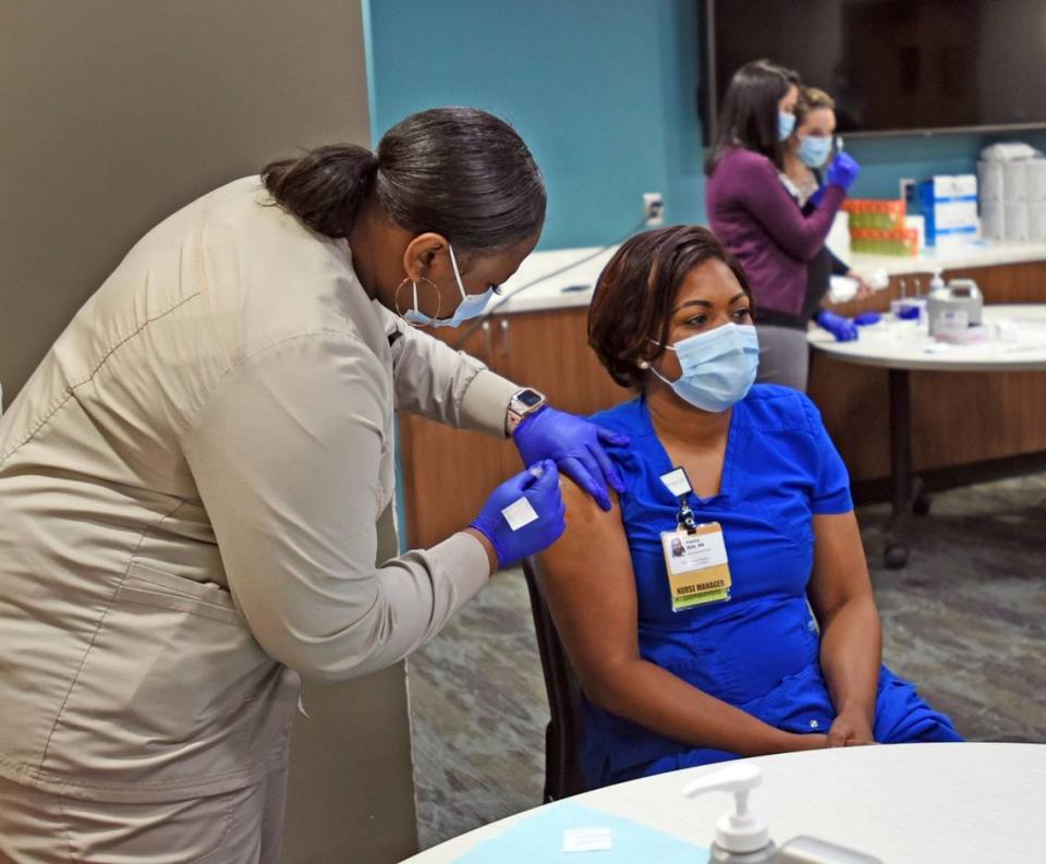 Venice Williams, a nurse manager at Wake Forest Baptist Medical Center, receives the COVID-19 vaccine Tuesday, Dec. 15, 2020, at the medical center.