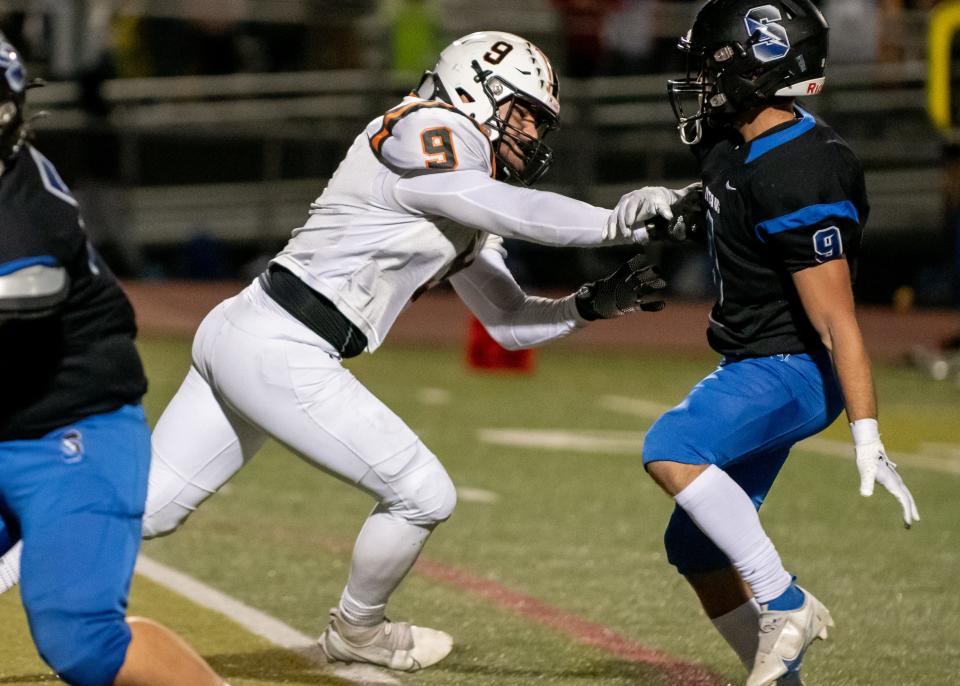 Pennsbury's Cade Gabbett makes a run towards the quarterback, as he pushes past Central Bucks South's Sebastian Pacchione in a football game at Central Bucks South in Warrington on Friday, September 23, 2022. The Falcons defeated the Titans 28-6.