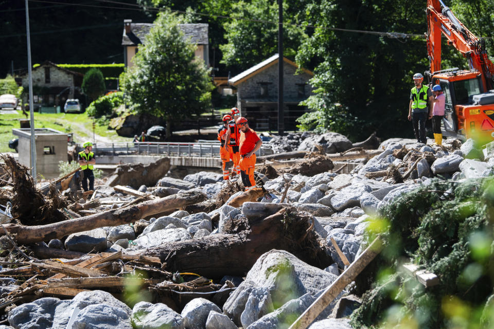 Cleanup work is underway at the Sorte village, community of Lostallo, Southern Switzerland, after a landslide, caused by the bad weather and heavy rain in the Misox valley, in Lostallo, Southern Switzerland, Saturday, June 22 2024. Massive thunderstorms and rainfall led to a flooding situation on Friday evening after a landslide in the Misox valley. Four people went missing on Saturday morning. Several dozen people had to be evacuated from their homes in the Misox and Calanca regions. (Samuel Golay/Keystone via AP)