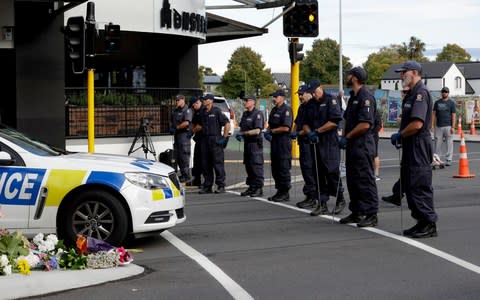 Police officers prepare to search the area near the Masjid Al Noor mosque, site of one of the mass shootings at two mosques in Christchurch - Credit: Mark Baker/AP