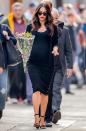 <p>Fox styled her pregnancy bump in a black knitted midi dress, black heels and a black knitted cardigan. She accessorised the look with a bunch of flowers, a red lip and sunglasses. </p>
