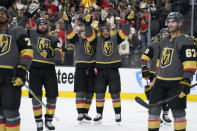 Vegas Golden Knights center William Karlsson, center left, and Vegas Golden Knights right wing Keegan Kolesar, center right, celebrate with teammates after defeating the Colorado Avalanche in Game 6 of an NHL hockey Stanley Cup second-round playoff series Thursday, June 10, 2021, in Las Vegas. (AP Photo/John Locher)