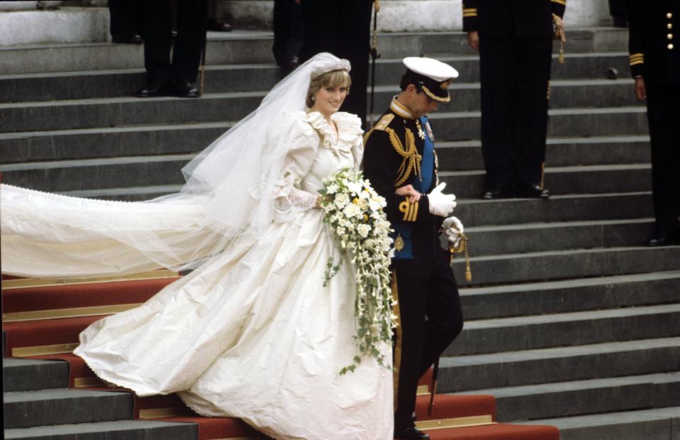 Princess Diana and Prince Charles on their wedding day in July 1981. The gown was designed by David and Elizabeth Emanuel and has a fitted bodice covered in panels of antique Carrickmacross lace. It originally belonging to Prince Charles’ great grandmother Queen Mary. It also features a 25-foot long train - the longest in royal history. The actor Emma Corrin wore a replica of the gown for the fourth series of The Crown, in which she portrayed Diana. (Shutterstock)