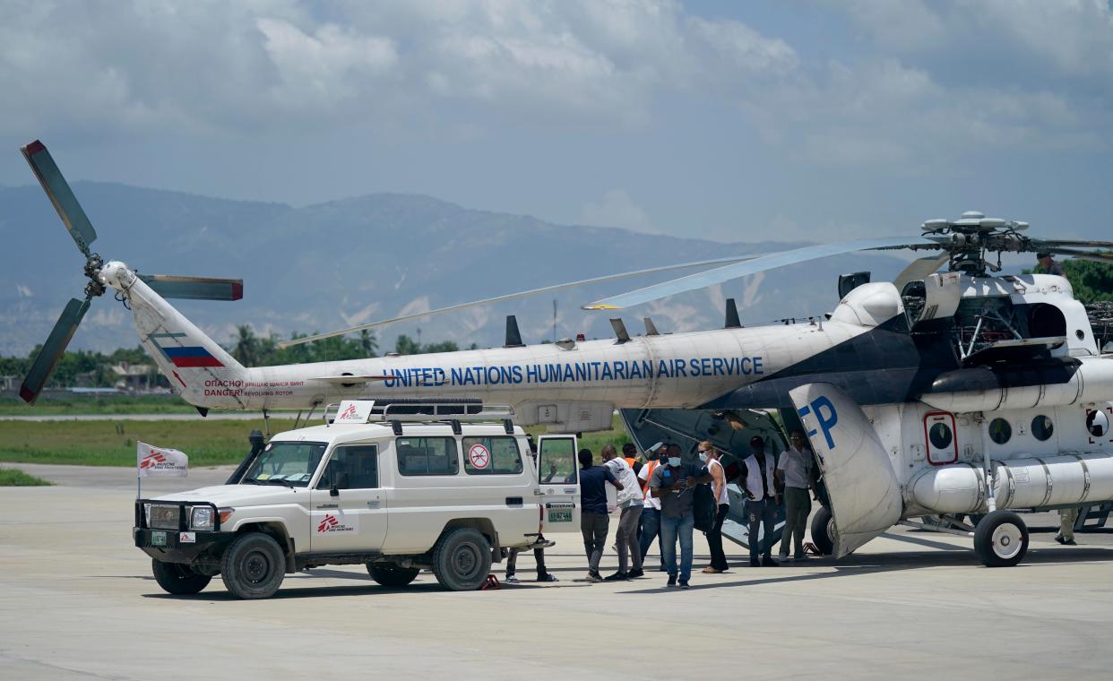 People load emergency supplies from a Doctors Without Borders ambulance into a United Nations helicopter bound for the earthquake-ravaged city Les Cayes at the local terminal of the Toussaint Louverture airport in Port-au-Prince, Haiti on Sunday, Aug. 15, 2021.