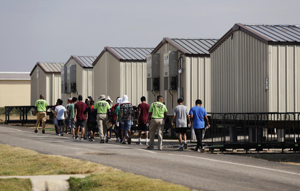 Image: Staff escort immigrants to class at the U.S. government's holding center for migrant children in Carrizo Springs, Texas, on July 9, 2019. (Eric Gay / AP file)