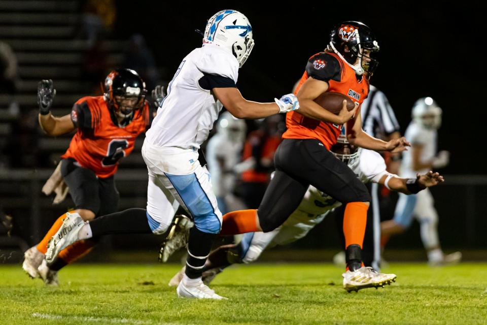 Diman’s Sam Perry runs the ball on Friday against Seekonk.