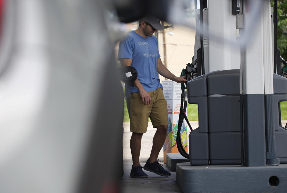 A motorist prepares to fill up the gasoline tank on his vehicle at a Shell station Thursday, July 22, 2021, in southeast Denver. Colorado drivers are facing some of the highest prices per gallon at the pump in more than a decade. (AP Photo/David Zalubowski)