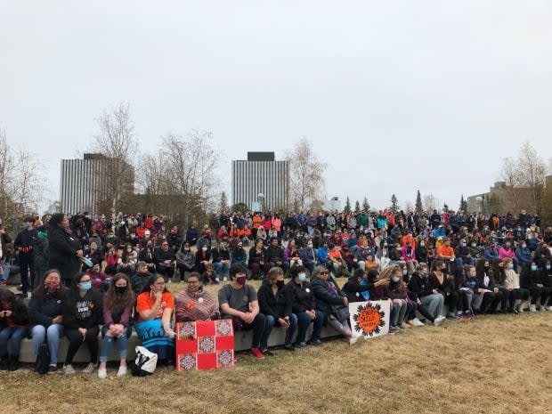 The crowd attends a feeding the fire ceremony at Somba K'e Park.