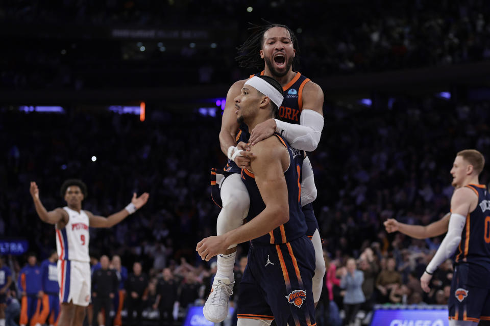 New York Knicks guard Jalen Brunson, top, jumps on teammate Josh Hart after Hart was fouled by the Detroit Pistons during the second half of an NBA basketball game Monday, Feb. 26, 2024, in New York. (AP Photo/Adam Hunger)