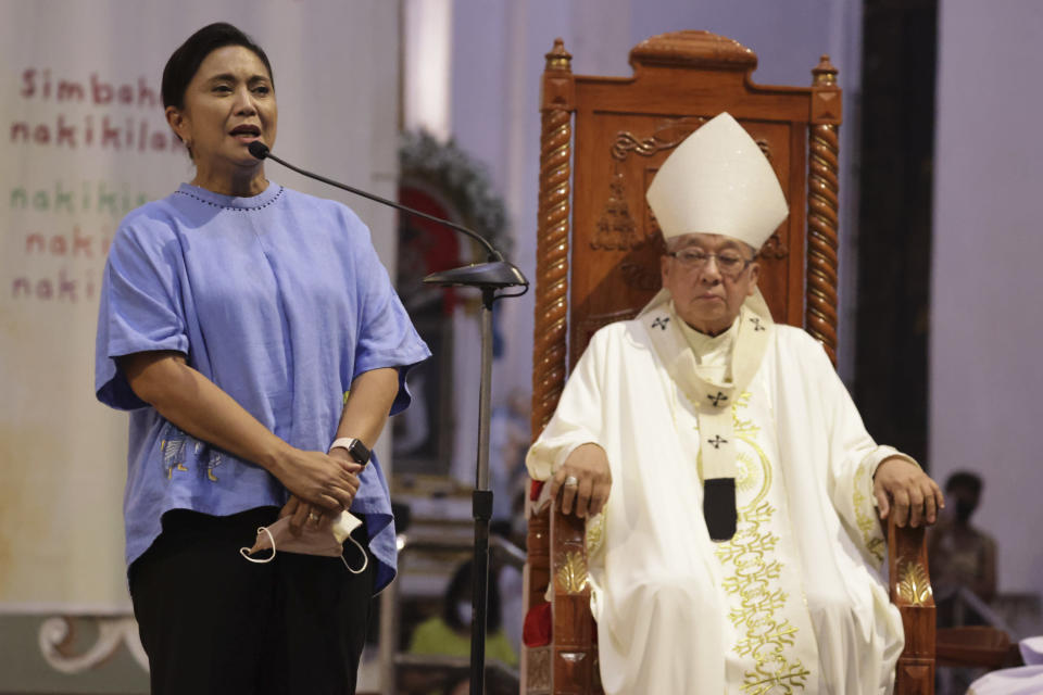 In this handout photo provided by the Office of the Vice President, Presidential candidate, incumbent Vice President Leni Robredo, left, talks beside Archbishop Rolando Tirona as she hears mass in Naga City, Camarines Sur, eastern Philippines Tuesday, May 10, 2022. The namesake son of late Philippine dictator Ferdinand Marcos appeared to have been elected Philippine president by a landslide in an astonishing reversal of the 1986 "People Power" pro-democracy revolt that ousted his father. (Office of the Vice President via AP)