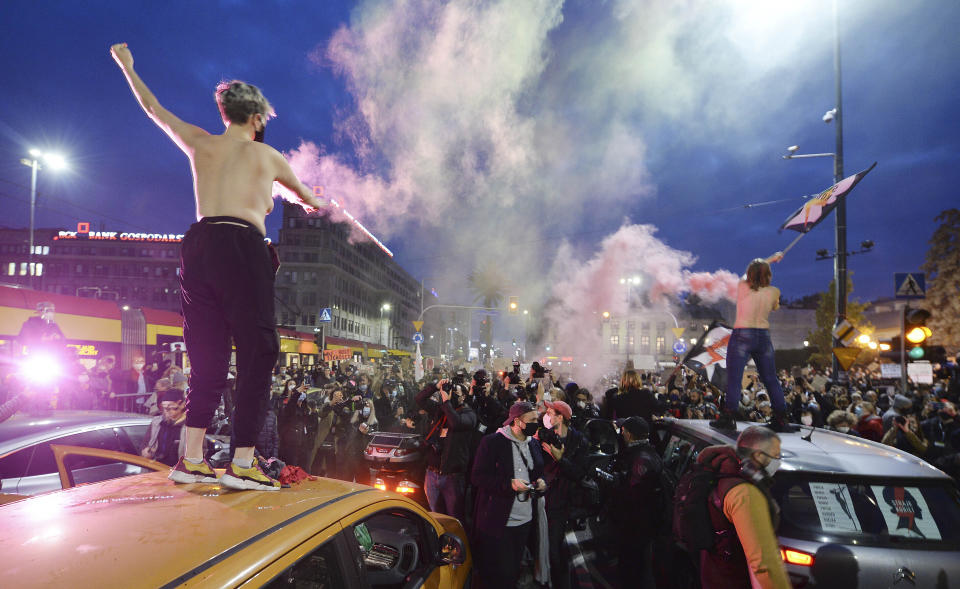 Angered women's rights activists and their supporters block rush-hour traffic at a major roundabout on the fifth day of nationwide protests against recent court ruling that tightened further Poland's restrictive abortion law, in Warsaw, Poland, on Monday, Oct. 26, 2020. The court effectively banned almost all abortions. (AP Photo/Czarek Sokolowski)