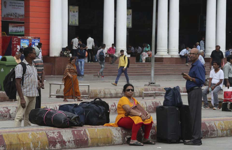 Passengers wait for transportation during a public transport strike in New Delhi, India, Thursday, Sept. 19, 2019. Commuters in the Indian capital are facing problems as a large section of the public transport, including private buses, auto-rickshaws and a section of app-based cabs Thursday remained off the roads in protest against a sharp increase in traffic fines imposed by the government under a new law.(AP Photo/Manish Swarup)