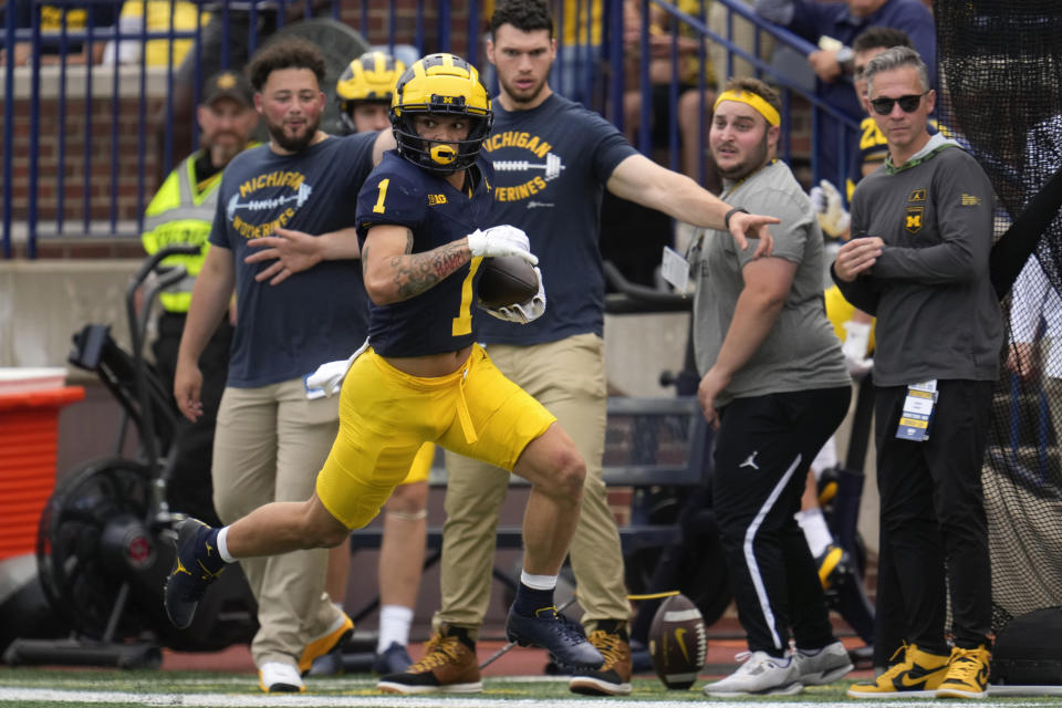 Michigan wide receiver Roman Wilson (1) runs after a catch on a 47-yard touchdown against UNLV in the second half of an NCAA college football game in Ann Arbor, Mich., Saturday, Sept. 9, 2023. (AP Photo/Paul Sancya)