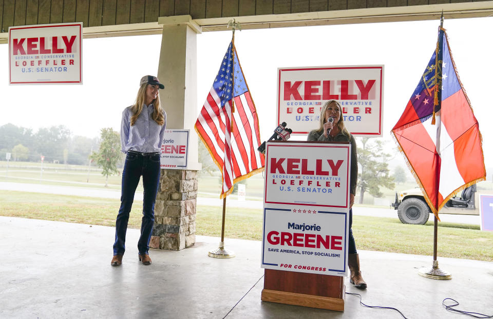 Marjorie Taylor Greene, right, during a news conference with Sen. Kelly Loeffler, R-Ga., left, on Thursday, Oct. 15, 2020, in Dallas, Ga. (AP Photo/Brynn Anderson)