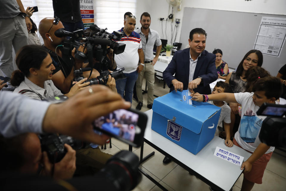 FILE - In this Tuesday, Sept. 17, 2019 file photo, Israeli Arab politician Ayman Odeh casts his vote in Haifa, Israel. Israel’s Arab coalition appears poised to emerge as the main opposition bloc following Tuesday’s vote. The historic first would grant a new platform to a long-marginalized minority and the only major political movement still pushing for peace with the Palestinians. (AP Photo/Ariel Schalit, File)