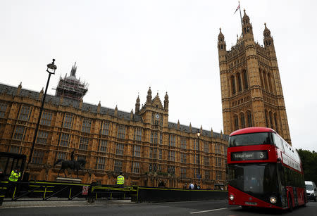 Police officers stand at the vehicle barrier to the Houses of Parliament where a car crashed after knocking down cyclists and pedestrians yesterday in Westminster, London, Britain, August 15, 2018. REUTERS/Hannah McKay