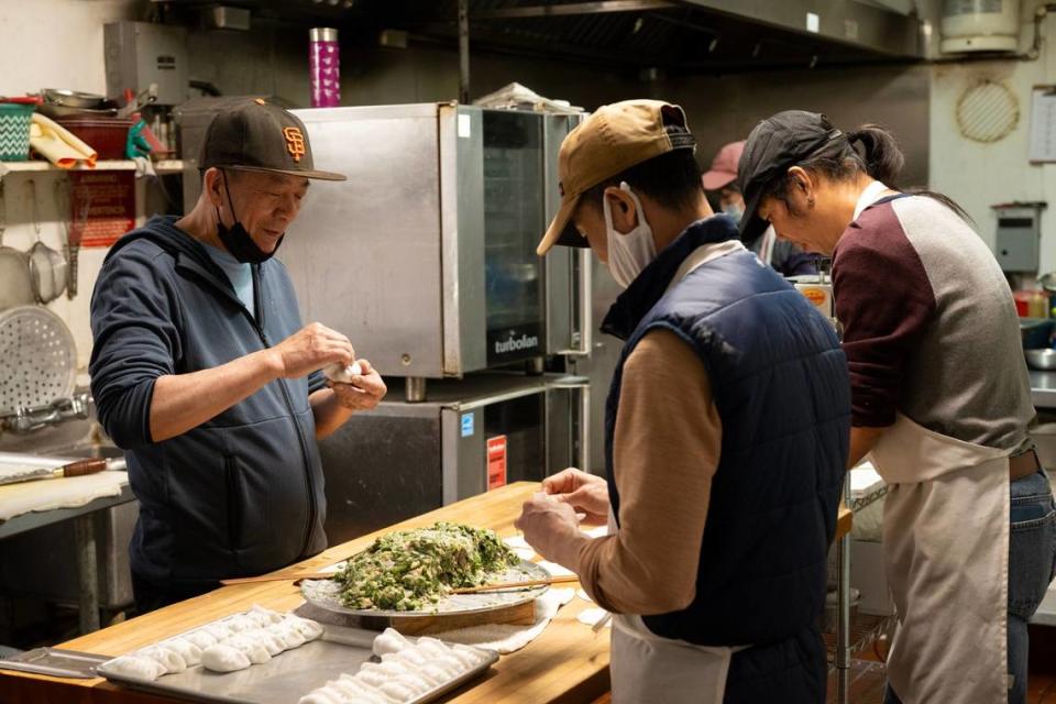 Owner Yao Li, left, and his staff make dim sum filled with chives, chicken and shrimp at Lam Kwong Deli & Market on March 20.