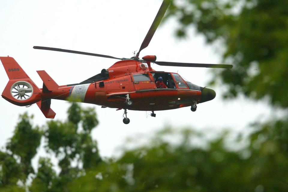 A Coast Guard helicopter, like the one shown here, rescued three people on Saturday from a capsized vessel in Great Bay off Little Egg Harbor.