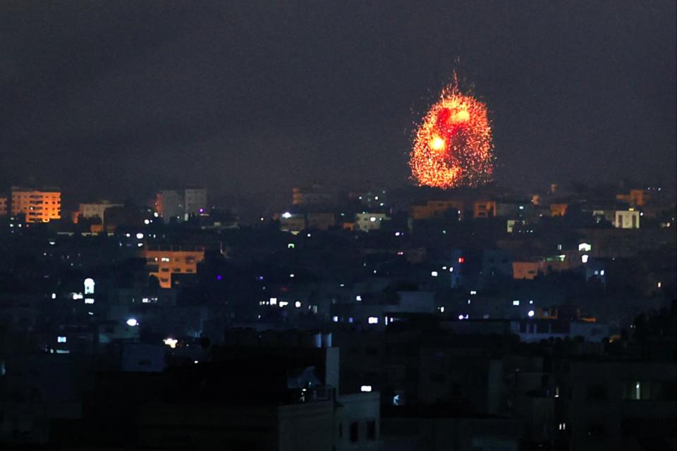 An explosion lights the sky following an Israeli air strike on Beit Lahia in the northern Gaza Strip (AFP via Getty Images)