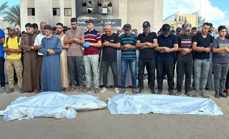 Relatives of Palestinians killed in the Israeli attacks perform funeral prayers infront their bodies ahead of their burial at Nasser Hospital following Israeli army launched an attack on Hamad Town and other areas in Khan Yunis, located in south Gaza Strip. Abdullah Abu Al-Khair/APA Images via ZUMA Press Wire/dpa