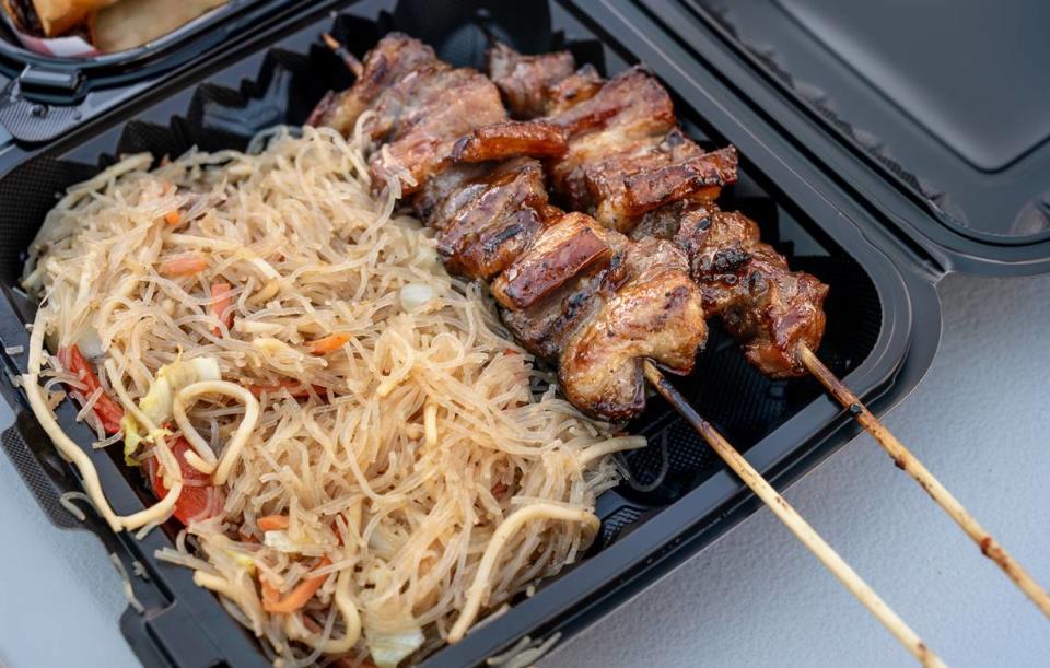 Pancit combo, stir fried rice noodles and pork skewers at Filipino Corner food truck on McHenry Avenue in north Modesto, Calif., Friday, June 16, 2023.