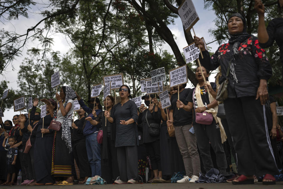 Tribal Kuki community members hold placards during a protest in Churachandpur district, in the northeastern Indian state of Manipur, Tuesday, June 20, 2023. Manipur is caught in a deadly conflict between minority Christian Kukis and mostly Hindu Meiteis. Some Meiteis fear that the hill tribes are using illegal drugs to finance a war to finish them off. On the other side, Kukis worry for their safety and now seek federal rule over the state and administrative autonomy for the community. (AP Photo/Altaf Qadri)