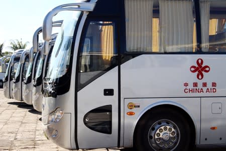 Buses gifted from China for the Pacific Games are parked at a Beijing-refurbished aquatic centre in Apia