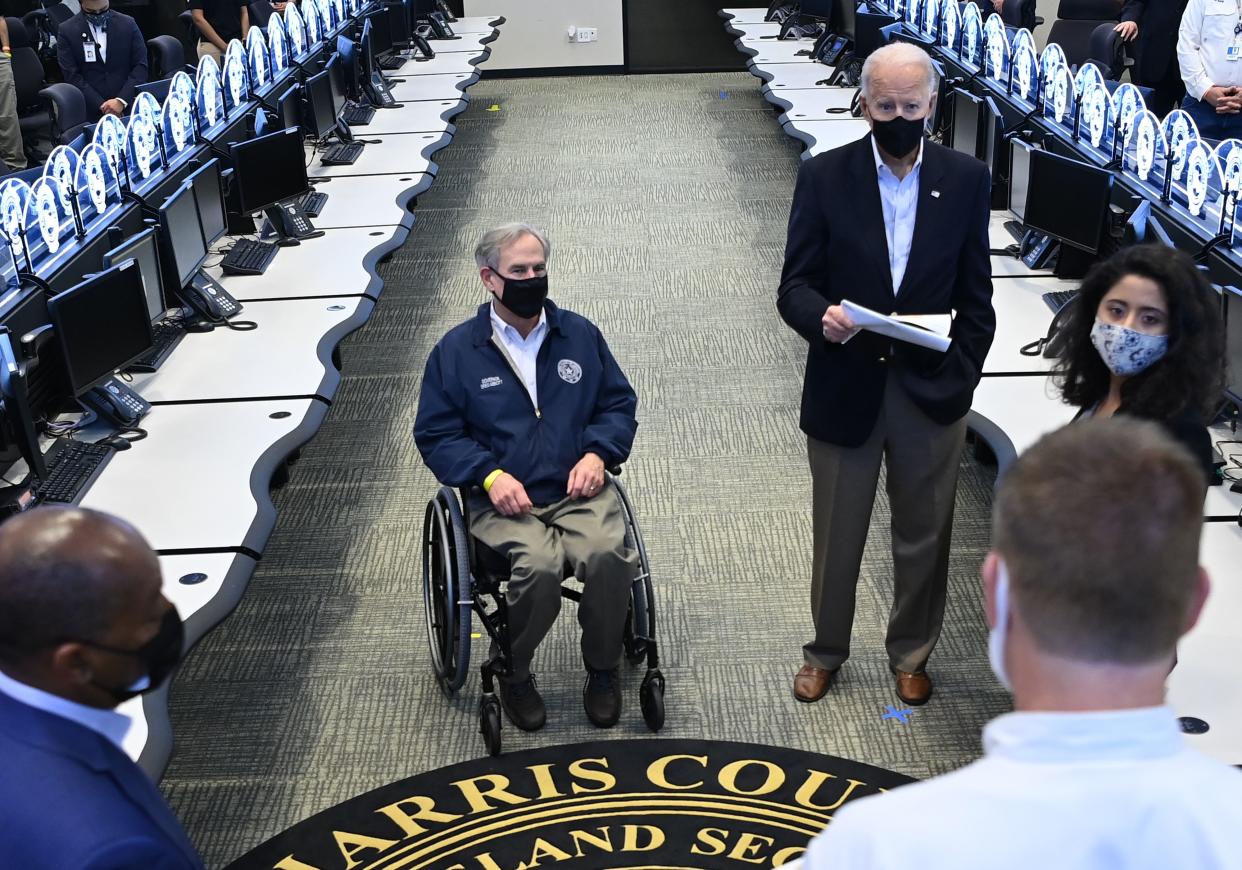 <p>US President Joe Biden and Texas Governor Greg Abbott listen to officials at the Harris County Emergency Operations Center in Houston, Texas.</p> (Photo by MANDEL NGAN/AFP via Getty Images)