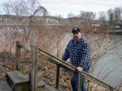 Paul Garrett stands on a stairway in front of his house which leads down to the banks of the Susquehanna River in Jersey Shore, Pa. on Sunday, March 23, 2014. Garrett, who now pays $2,200 per year for flood insurance on his house that sits on the high riverbank, said he could take a year or two of 10 or 15 percent increases. But he says the threat that rates might go higher could render the house both unaffordable and potentially unmarketable. (AP Photo/Ralph Wilson)