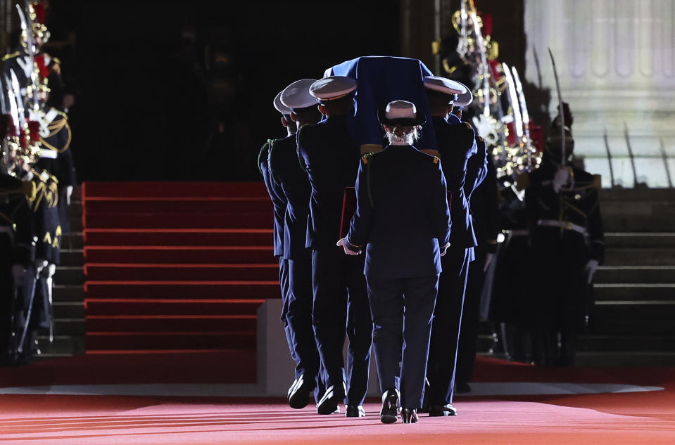 Six carriers of the Air Force and Space carry the cenotaph of Josephine Baker, covered with the French flag, into the Pantheon in Paris, France, Tuesday, Nov. 30, 2021, where she is to symbolically be inducted, becoming the first Black woman to receive France's highest honor. Her body will stay in Monaco at the request of her family. (Thomas Coex/Pool Photo via AP)