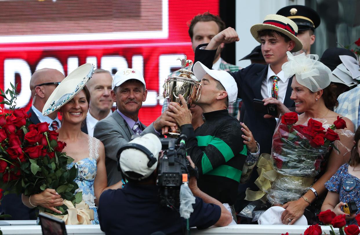 Brian Hernandez Jr. kissed the winning trophy as he celebrated in the winners circle after he rode Mystik Dan to win a photo finish at the Kentucky Derby in Louisville, Ky. on May. 4 2024.